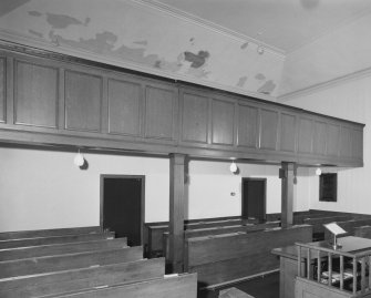 View of balcony and pews underneath balcony from South West