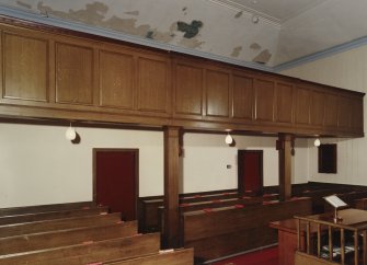 View of balcony and pews underneath balcony from South West