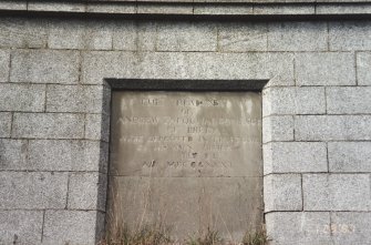 Memorial plaque set into outer face of NE side of mausoleum

