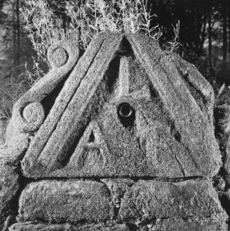 View of carved pediment with water spout