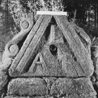 View of carved pediment with water spout (including scale)