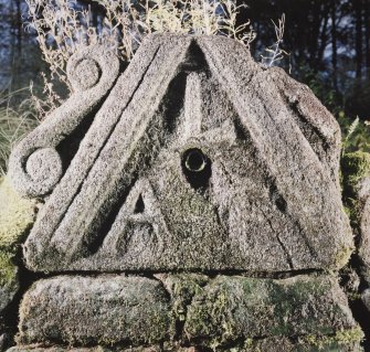 View of carved pediment with water spout