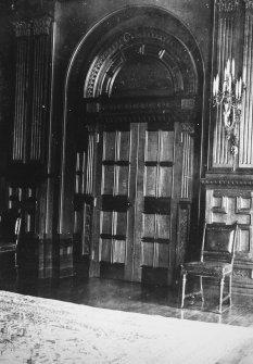 Interior. Round arched double doors flanked by pairs of fluted pilasters.