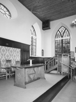 Interior, view of raised platfom from NW with communion table and pulpit