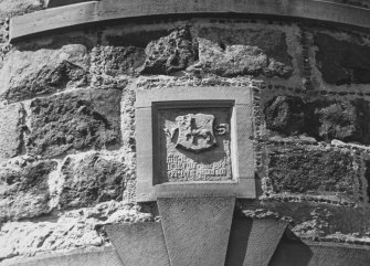 Detail of inscribed pediment reset in modern block.