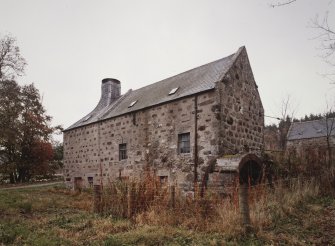 General view of mill from SW, showing water wheel (with rim gear) on S end of building