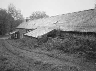 View from NNE along E side of steading, showing (halfway up) water-wheel house (water wheel, which drove the threshing barn has been removed).