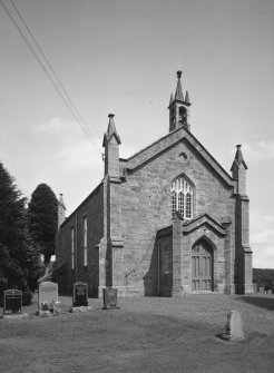 General view from W showing entrance porch and bellcote.