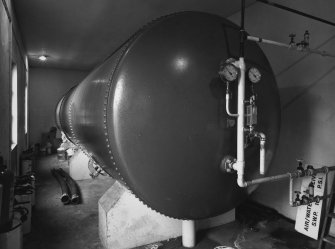 Interior.
View of riveted, dome-ended tank containing compressed air and water for the sprinkler system.