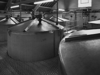 Interior.
Still House: view of stainless steel charge vessels holding wash for supplying wash stills, and low feints for supplying spirit stills.