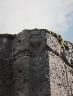 Close-up view of anthropomorphic face at the head of a hollow chamfer in the dressing of a window opening at the W end of the S side of the Great Hall.
