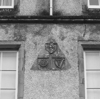 Leith Hall, exterior.  Detail of carved pediment above West entrance showing Thistle, Rose and Harp reliefs