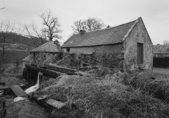 View from SW along W side of mill, showing lade and water wheel