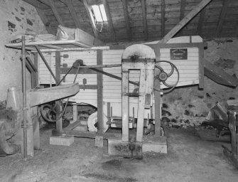 Interior: Barn, view of threshing machine