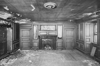 General view of interior of North apartment on first floor of old North block showing fireplace and panelling on North wall.