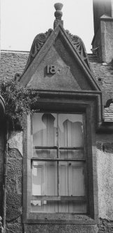 Detail of pedimented dormer window dated 1887 on West front.