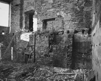 Interior.
View of lower section of North wall showing South wall of tower in drawing room.