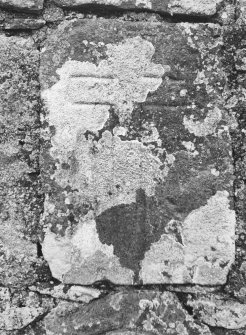 General view of cross-marked grave-slab built into North-West wall, North-East of gate.