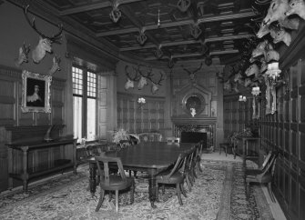 Interior. Ground floor view of dining room from East showing original furnishings, fittings and stags heads installed for the Earls of Fife