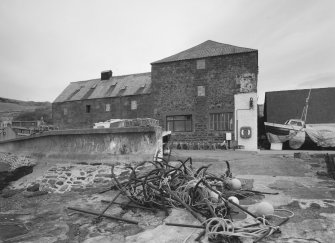 General view from S (harbour side), showing former granary (right) and fish-processing bays (left), which were added in 1896