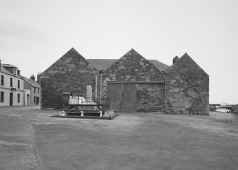 General view from W showing three bays forming fish processing works, the S (right) bay still containing one of four original smoke kilns.  The plaque in the gable of the central bay contains the date 1896, and the initials JSB (John S Boyle), who erected the building during the herring boom