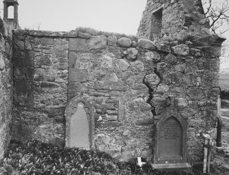 Detail of East wall with gravestone and moulded roussoir in North aisle.