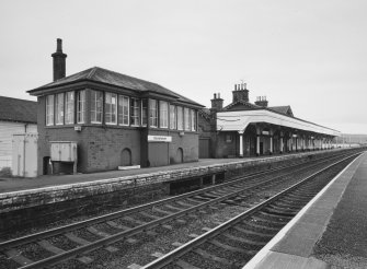General view from N of signal box (left), station offices and south-bound platform and awning