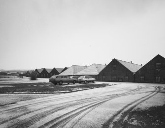 General view from NW of ranges of Duty Free Warehouses to SE of distillery.