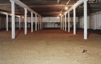 Interior.
View from WNW in Maltings of newly laid floor of barley.