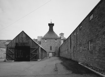 General view from SW of NW maltings kiln, with range of former maltings floors to right, and cask store to left.