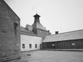 View from W of NW maltings Kiln, with cask store to right.