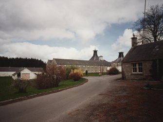View of distillery from S, showing Duty Free Warehouse No.2, former Maltings and Kiln, and distillery cottage.
