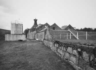 General view from N of NW end of main range of distillery's production buildings.