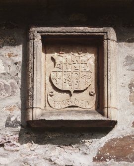 Detail of carved armorial panel on S wall.