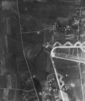 RAF WWII vertical aerial photograph of W part of airfield during the construction phase.Visible are taxiways and part of E-W runway. Also seen on the image is the small village of Nether Dallachy.