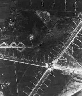 RAF WWII vertical aerial photograph of the main runway crossing point of Dallachy Airfield during the construction phase.  Visible are several anti-landing ditches.