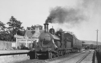 View from NW showing train at station.