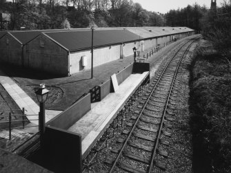 View from NW of Strathisla Halt on branch railway (Keith to Dufftown, currently not used by British Rail, but frequented by Whisky Specials in the summer), with bonded warehouses in background.
