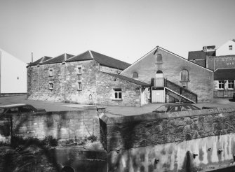 View from SW of W part of distillery, containing Engineers' Workshop.
