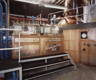 Interior.
View from E of Spirit Safe in Still House. 
