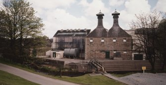 General view of main production block of distillery (left: Still House, centre: kilns) from W