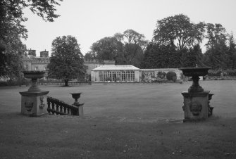 Conservatory and main house, distant view from formal garden steps