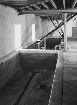 View of concrete steeps )with drain covers removed) and grain chute from malt-loft above