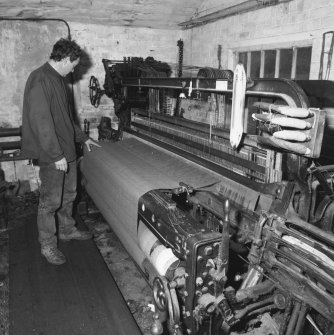 Interior.
View of mill owner, Hugh Jones, operating a Dobcross Loom in the weaving shed.