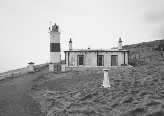General view of lighthouse and compound from NE, with sundial in foreground