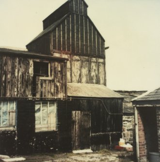 Photographic copy of colour polaroid showing general view of kiln and curing shed.