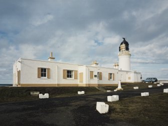 View from S of detached keepers' house (left), with lighthouse in background