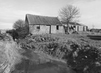 View of cottage and concrete shed from South West.