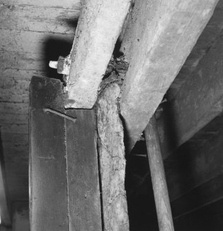 Stable, detail of wooden beams supporting Caithness slab partition.