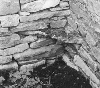 Remains of wooden tie spanning angle in byre